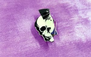 hard enamel pin of a skull and performers face