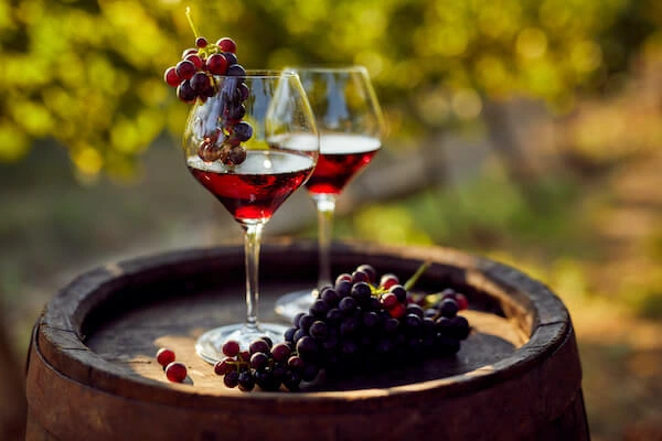 red wine glass with grapes under