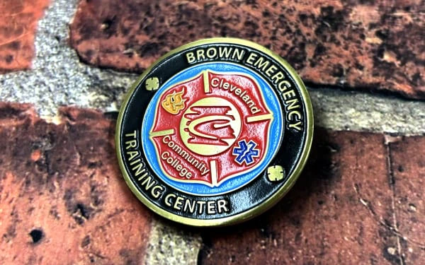 custom firefighter pin with blue and orange and red in the background