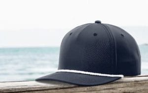 a sample 5-panel hat sitting by the water