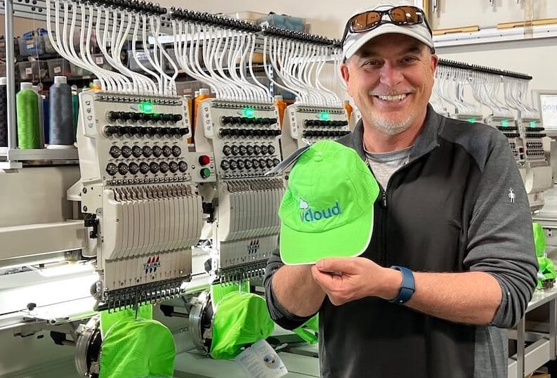 Paul Stark holding a custom hat