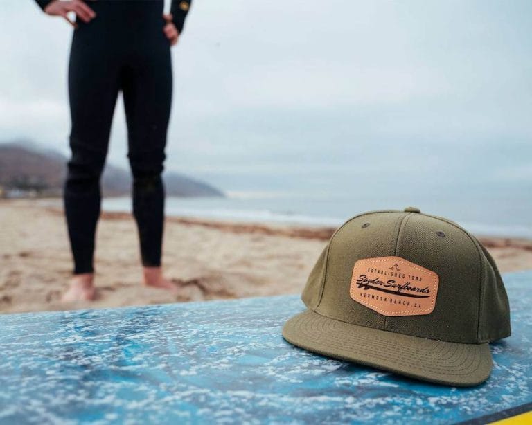 leather patch hat on surfboard