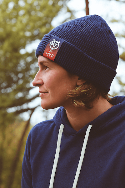 woman wearing beanie with red label