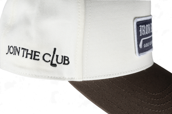 white hat with iron club embroidery on side of hat