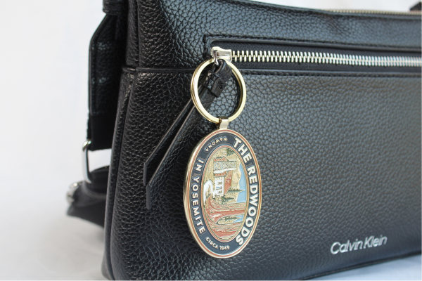 Soft enamel keychain hanging on purse